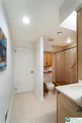 a bedroom with a bed and a mirror