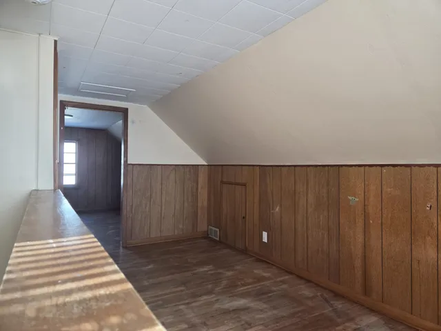 a view of a livingroom with wooden floor and stairs