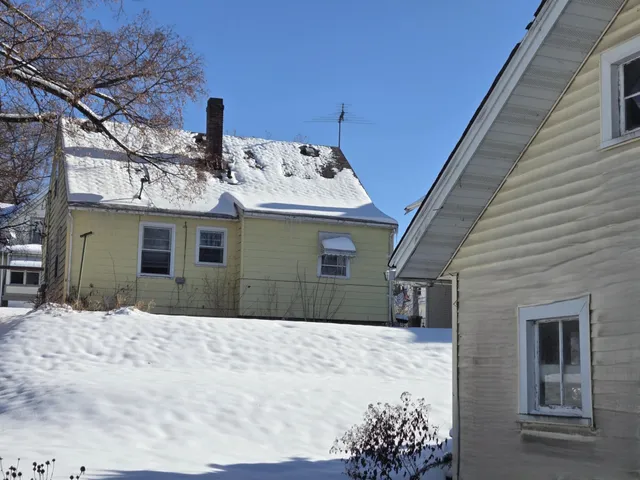 a view of a house with a snow in the yard