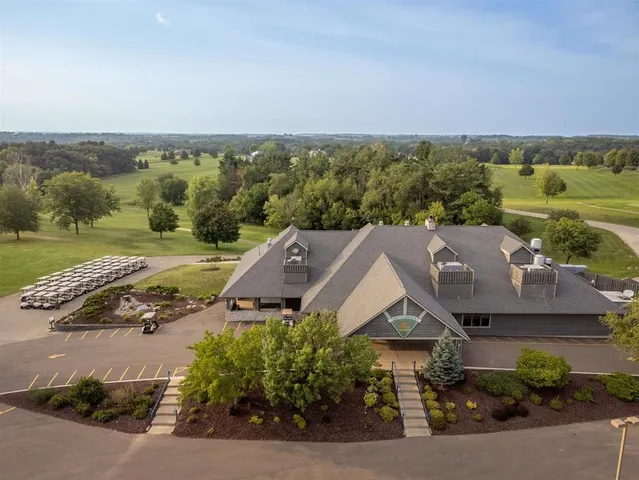 an aerial view of a house with a yard and lake view