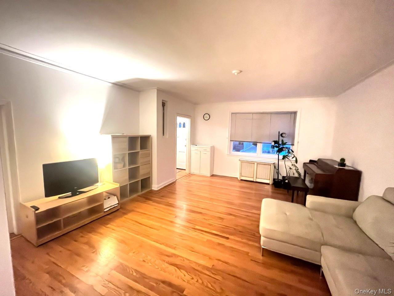 1945 Paulding Avenue Bronx, NY 10462 - Photo 12 of 12 a living room with furniture and a flat screen tv