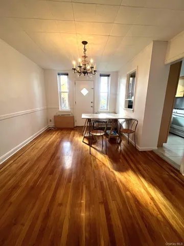 a view of a living room and kitchen with wooden floor