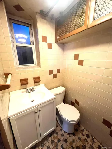 a bathroom with a sink a toilet and mirror