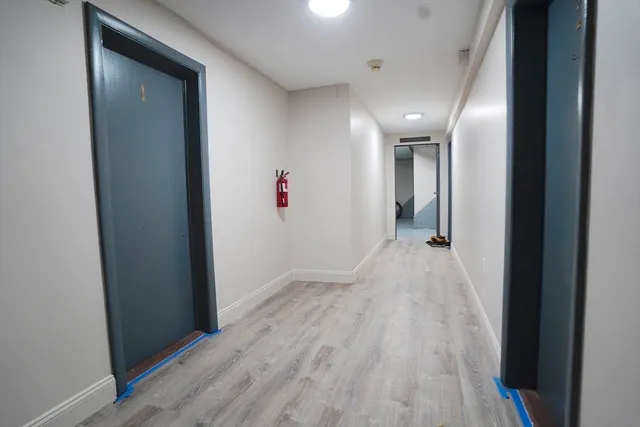 a view of hallway with wooden floor