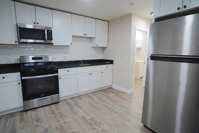 a kitchen with a refrigerator stove and microwave