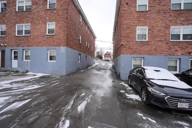 a car parked in front of a brick building