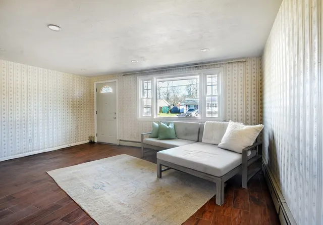 a living room with furniture and wooden floor