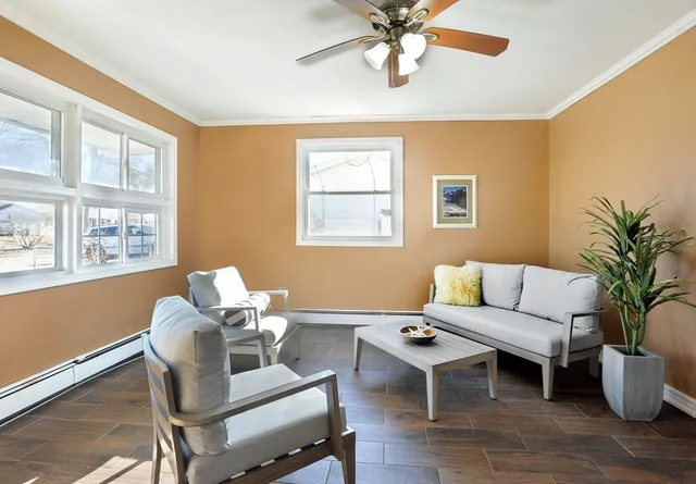 a living room with furniture wooden floor and a window