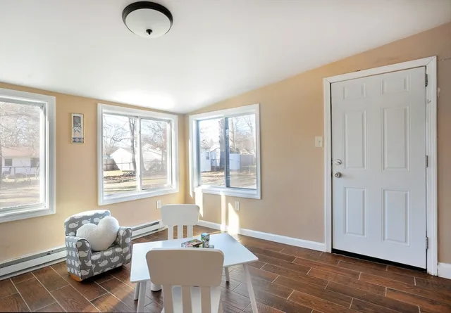 a living room with furniture and two window