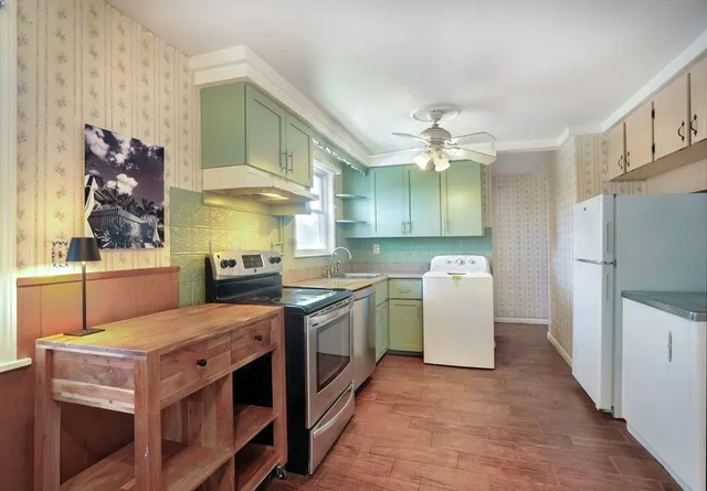 a kitchen with a stove a sink and a refrigerator