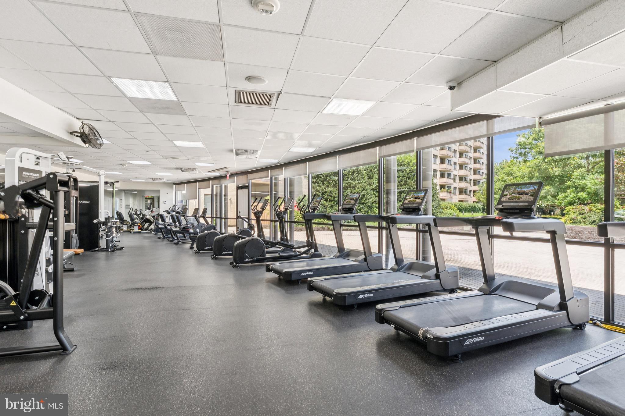 5225 Pooks Hill, Unit 710N Bethesda, MD 20814 - Photo 30 of 64 a room with gym equipment and large windows