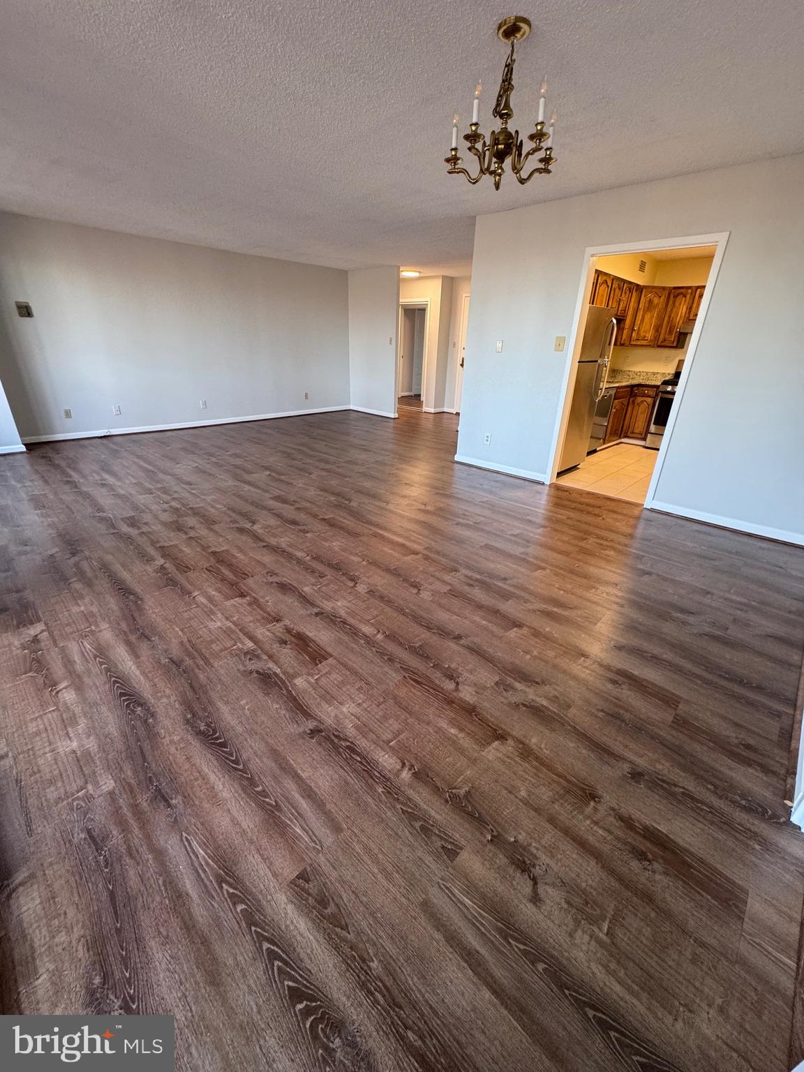 5225 Pooks Hill, Unit 710N Bethesda, MD 20814 - Photo 53 of 64 a view of an empty room with window and wooden floor