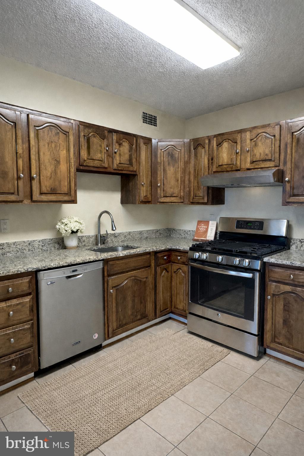 5225 Pooks Hill, Unit 710N Bethesda, MD 20814 - Photo 56 of 64 a kitchen with granite countertop a stove and a sink