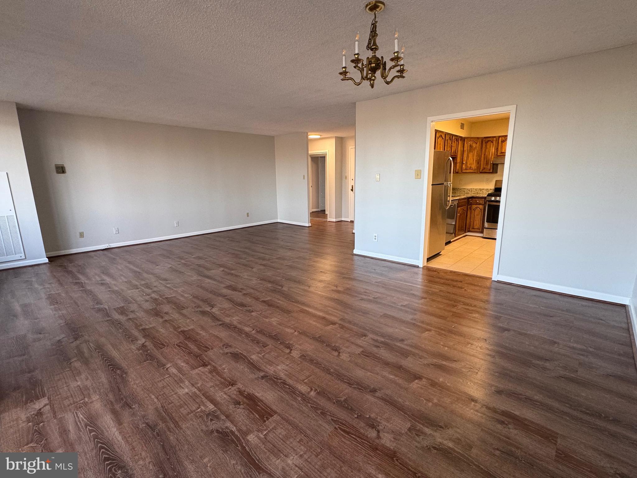 5225 Pooks Hill, Unit 710N Bethesda, MD 20814 - Photo 62 of 64 a view of an empty room with wooden floor and a window