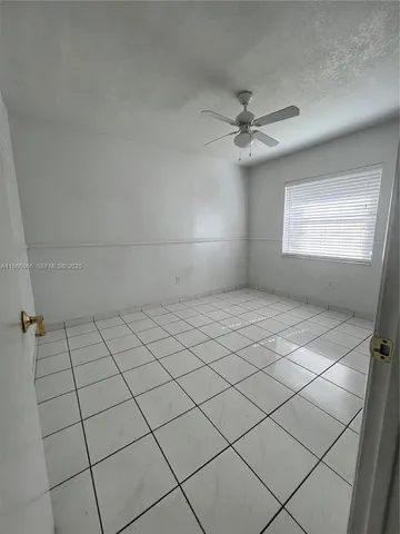 an empty room with staircase and white walls