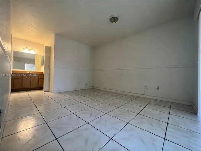 a view of an empty room and a window