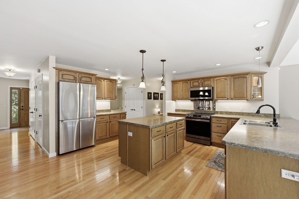 345 Bragg Road Warren, MA 01585 - Photo 12 of 41 a kitchen with stainless steel appliances granite countertop a sink stove and refrigerator