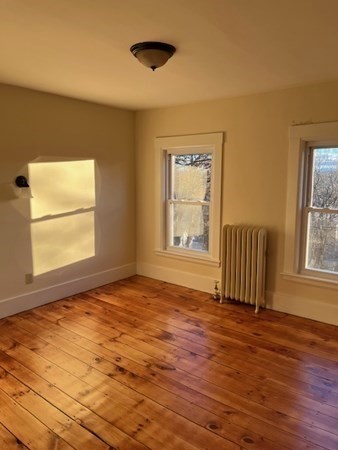 36 Cambridge Street Ayer, MA 01432 - Photo 19 of 28 an empty room with wooden floor and windows