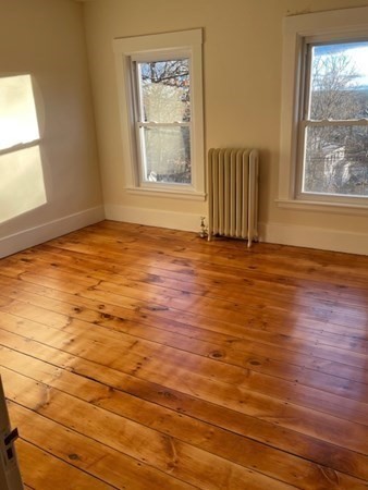 36 Cambridge Street Ayer, MA 01432 - Photo 23 of 28 an empty room with wooden floor and windows