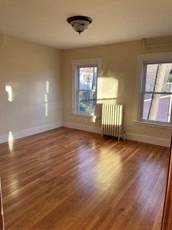 36 Cambridge Street Ayer, MA 01432 - Photo 4 of 28 an empty room with wooden floor and windows