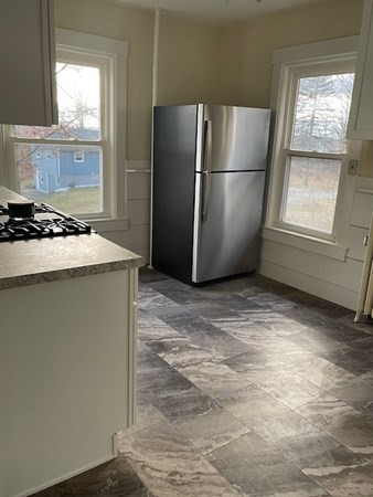 36 Cambridge Street Ayer, MA 01432 - Photo 5 of 28 a kitchen with stainless steel appliances granite countertop a refrigerator sink and stove
