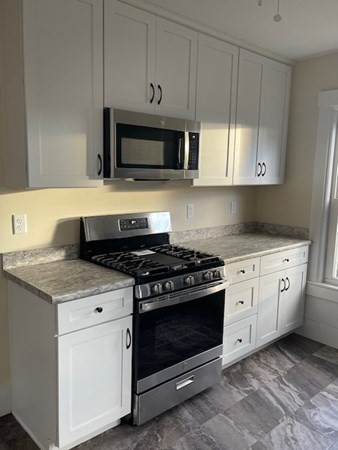 36 Cambridge Street Ayer, MA 01432 - Photo 7 of 28 a kitchen with white cabinets and appliances
