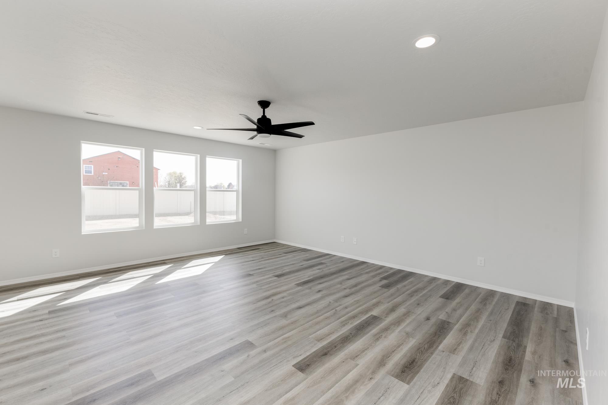 13681 Inman Court Caldwell, ID 83607 - Photo 11 of 31 Empty room featuring a ceiling fan, light wood-style flooring, and recessed lighting