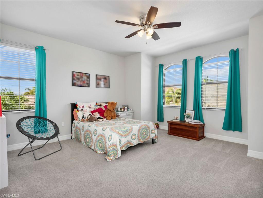 2756 Crystal Way Naples, FL 34119 - Photo 39 of 50 a bedroom with a bed and a large window