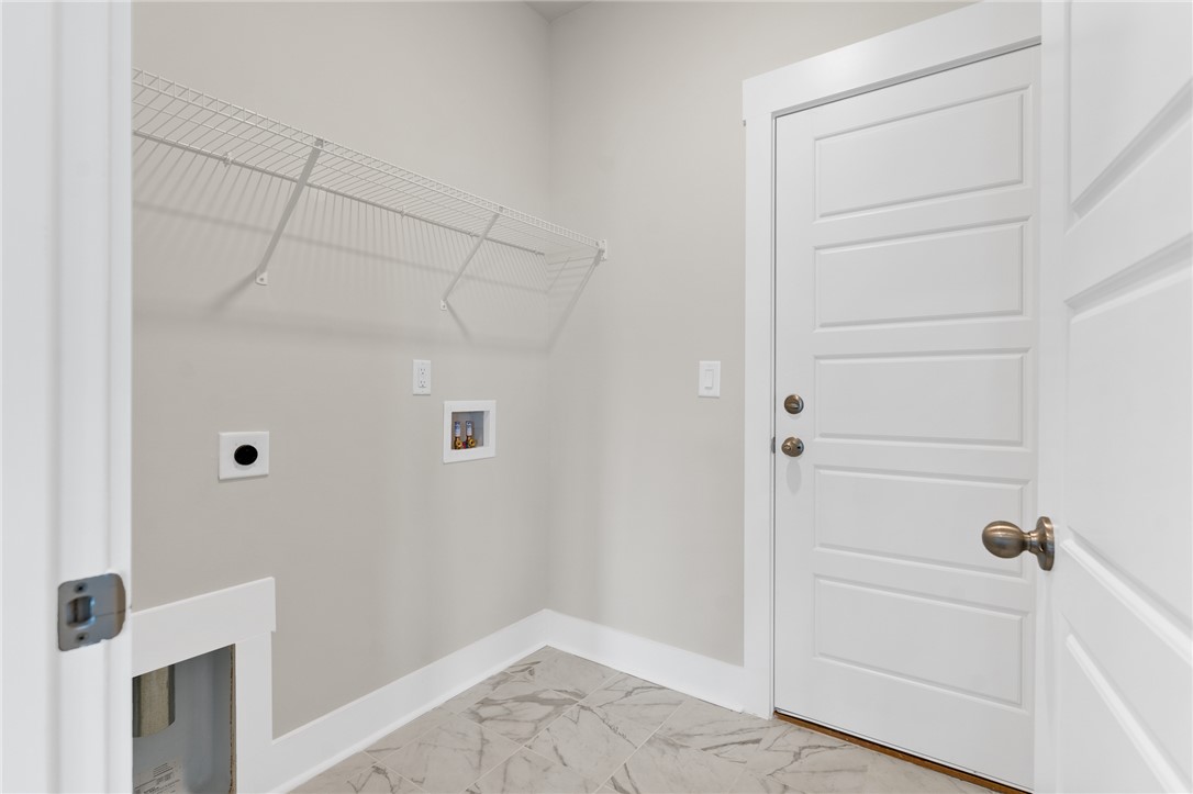 167 Tiger Lily Drive Anderson, SC 29621 - Photo 15 of 34 A well-appointed laundry space features practical wire shelving and durable tiled flooring.