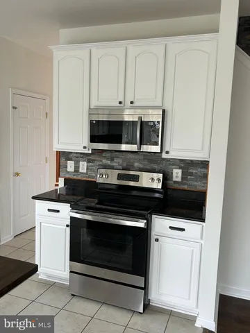 a spacious bathroom with a tub sink and mirror