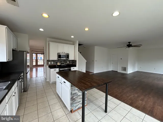 a spacious bathroom with a double vanity sink a mirror and a