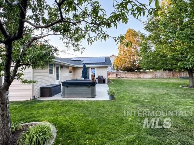 808 O'Leary Way Twin Falls, ID 83301 - Photo 31 of 37 Spacious backyard featuring a concrete patio, expansive lawn, and mature trees