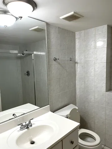 a bathroom with a sink toilet and shower