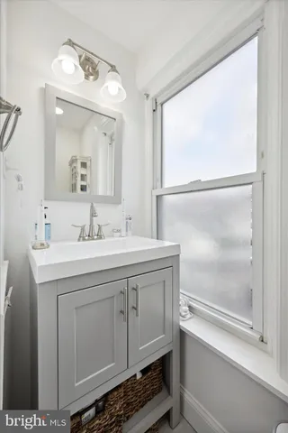 a bathroom with a sink a mirror and a vanity
