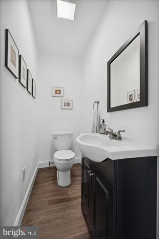 a bathroom with a toilet a sink and mirror