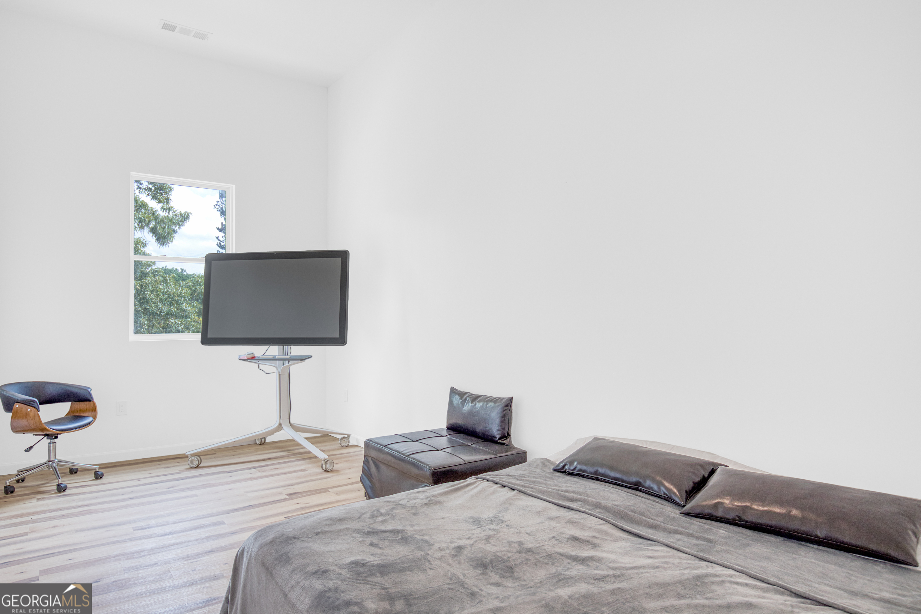 235 Candler Road Southeast Atlanta, GA 30317 - Photo 13 of 26 a bedroom with a bed and a flat screen tv