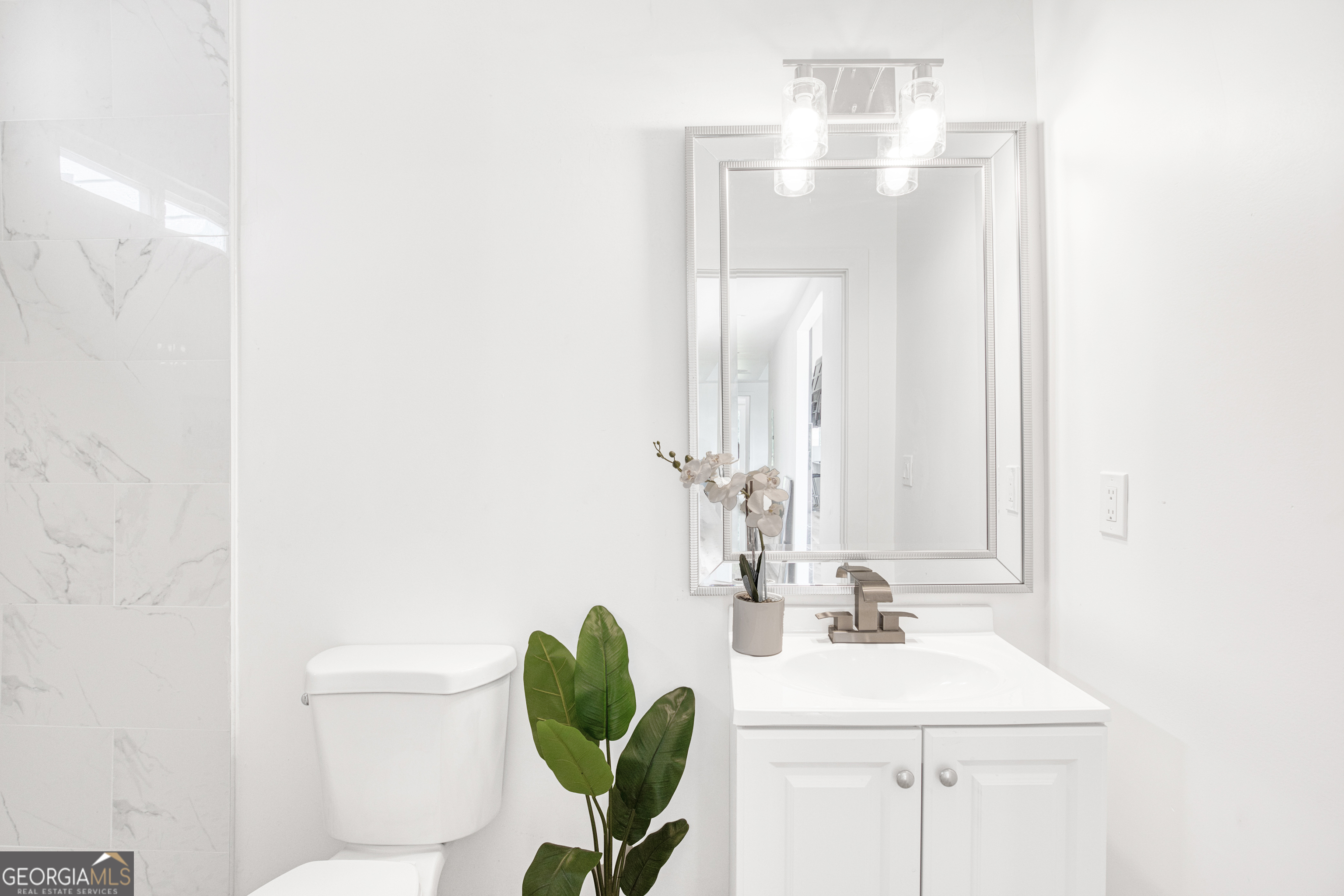 235 Candler Road Southeast Atlanta, GA 30317 - Photo 15 of 26 a bathroom with a sink a toilet and a mirror