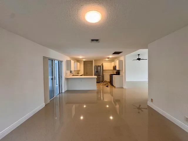 a view of a livingroom with furniture and a window
