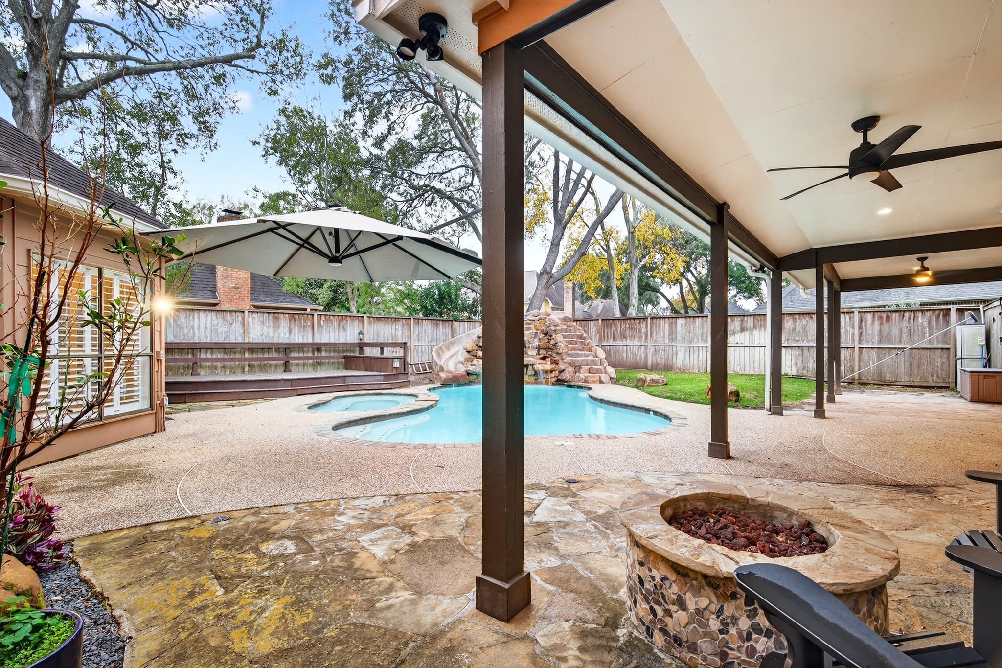 20006 Gable Point Drive Katy, TX 77450 - Photo 35 of 44 a view of a patio with a table chairs and a fire pit