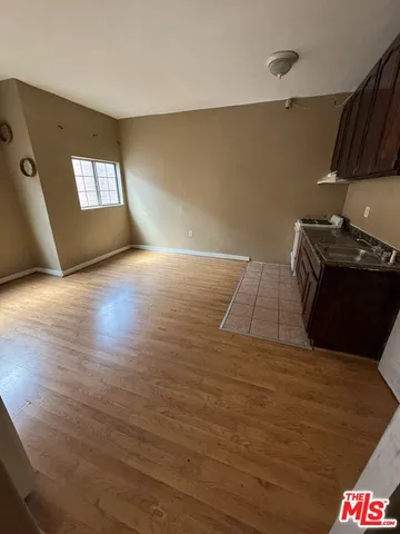 a view of an empty room and window in an empty room