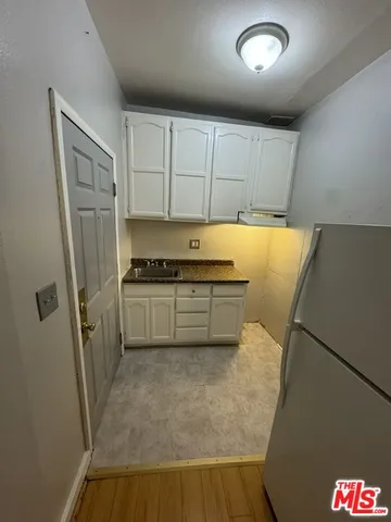 a utility room with cabinets washer and dryer
