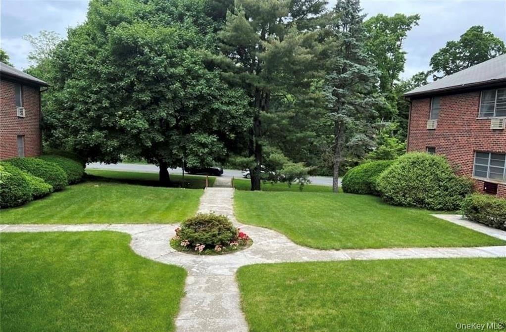 65 Curie Road, Unit G7 Cornwall-on-Hudson, NY 12520 - Photo 3 of 12 a view of a garden with a fountain