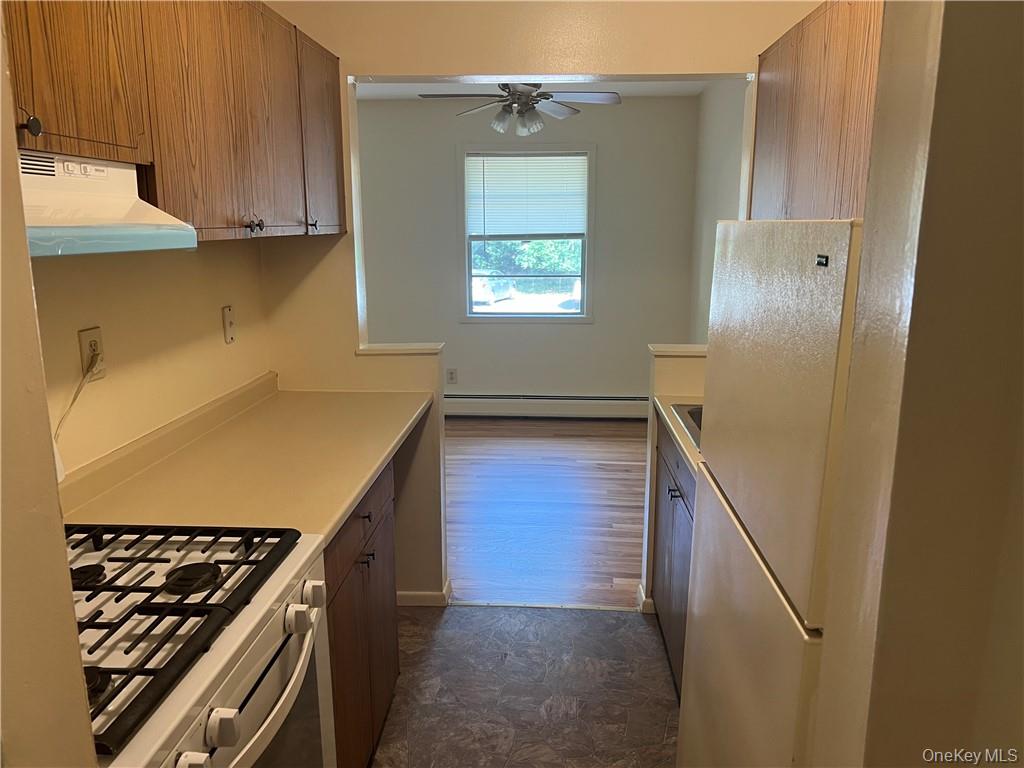 65 Curie Road, Unit G7 Cornwall-on-Hudson, NY 12520 - Photo 4 of 12 a kitchen with a refrigerator and a stove