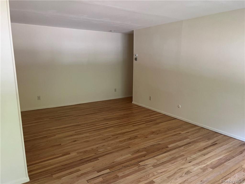 65 Curie Road, Unit G7 Cornwall-on-Hudson, NY 12520 - Photo 9 of 12 an empty room with wooden floor