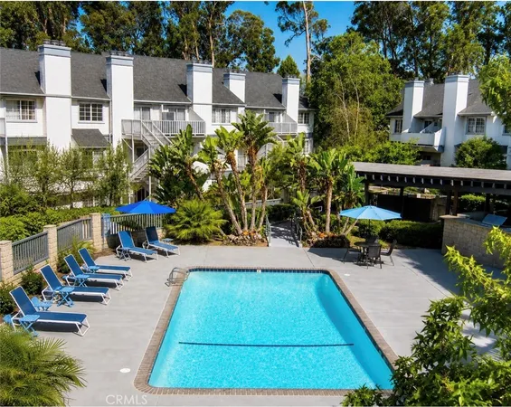 a view of a swimming pool with chairs in patio