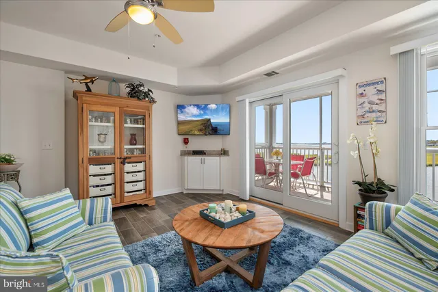 a living room with furniture and a dining table with wooden floor