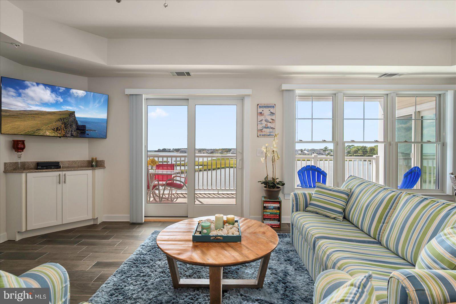 37292 Lighthouse Road, Unit 202 Selbyville, DE 19975 - Photo 12 of 78 a living room with furniture and a floor to ceiling window