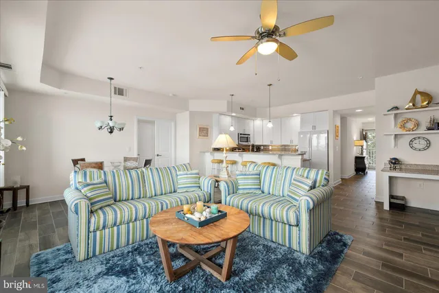 a kitchen with stainless steel appliances granite countertop a refrigerator a stove top oven a sink dishwasher and a refrigerator