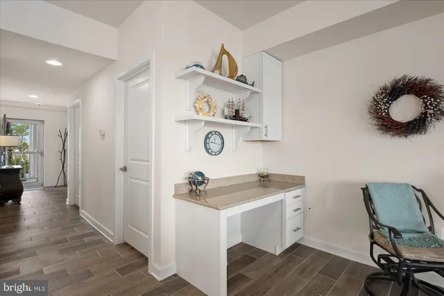 a kitchen with cabinets stainless steel appliances and a counter space