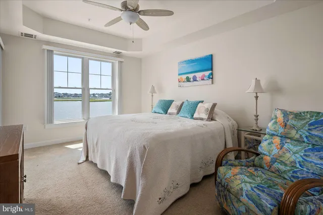 a spacious bathroom with a granite countertop sink a toilet and a mirror